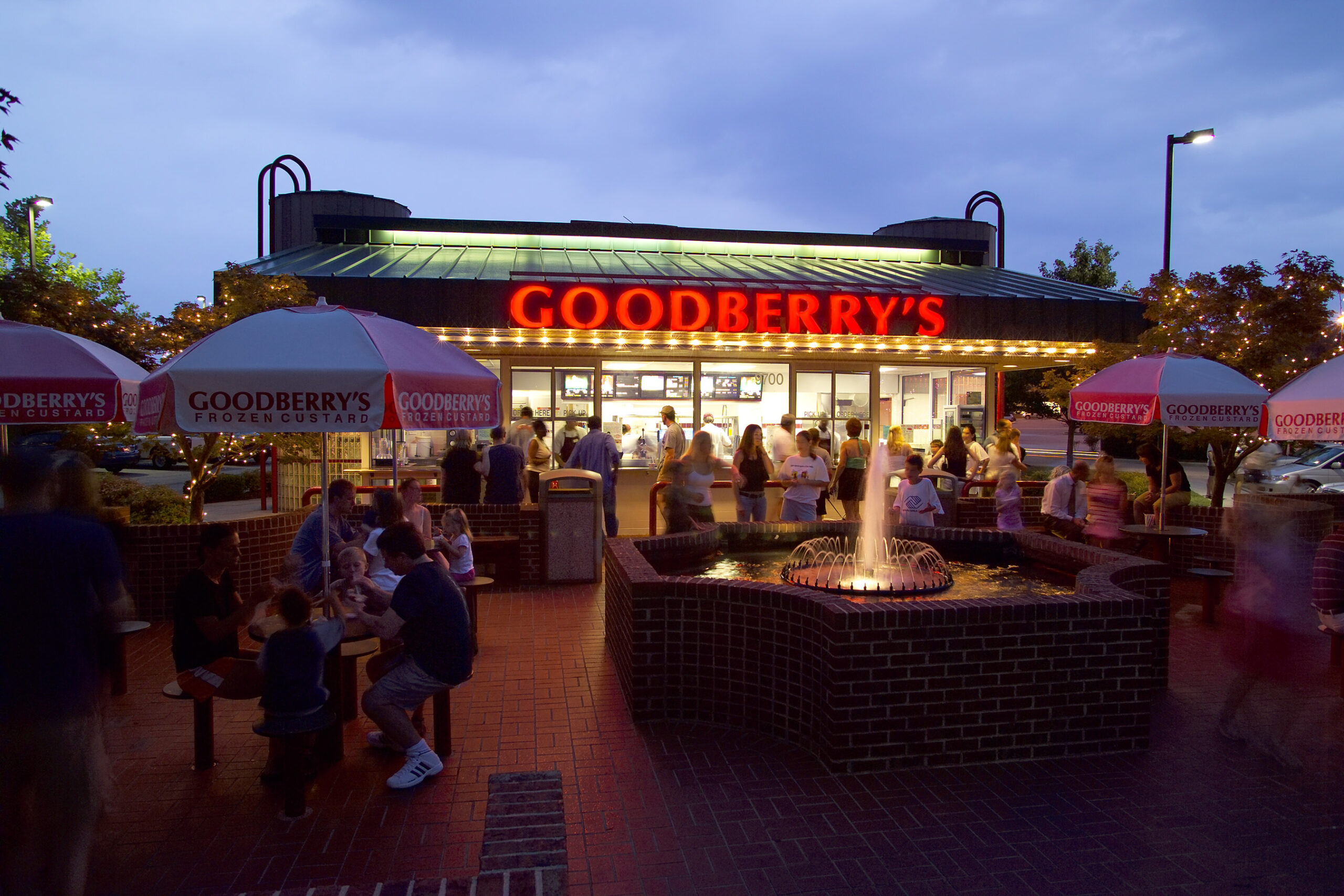 Guests gather at dusk in the courtyard of Goodberry's at Harvest Plaza on Strickland Road in Raleigh